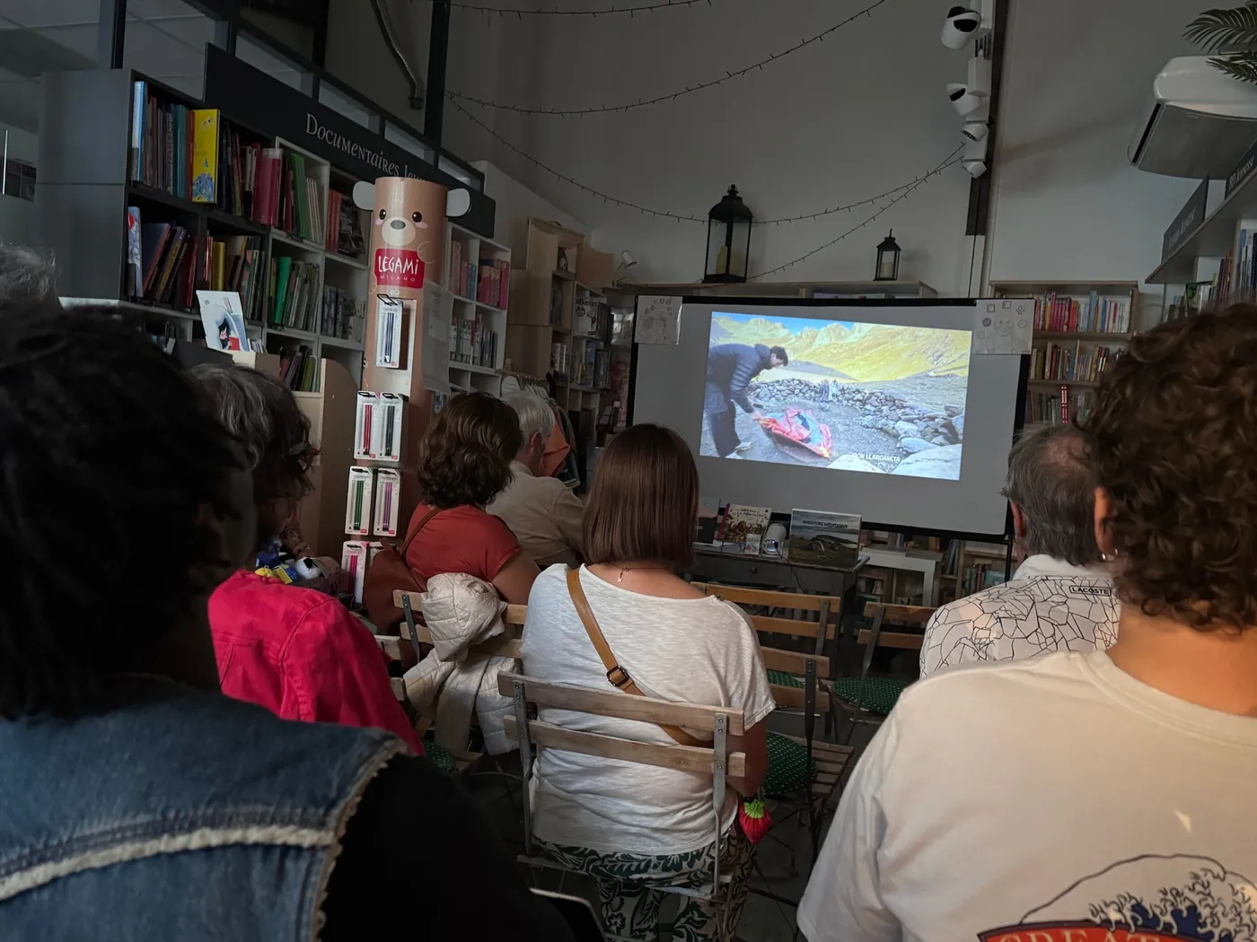 The audience watching the film in the bookshop