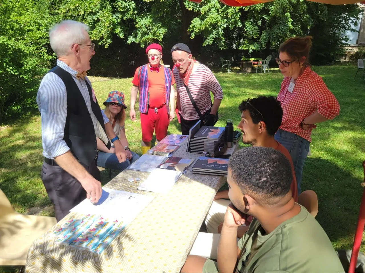 Chatting around the stand’s table with visitors, including two clowns