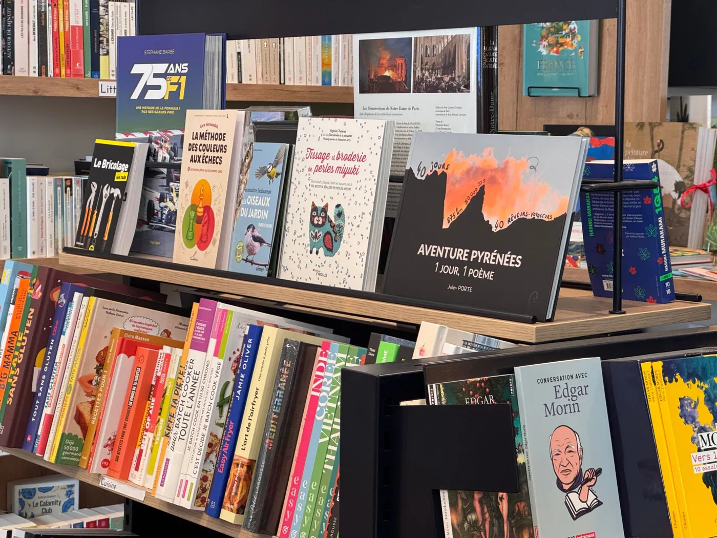 Aventure Pyrénées on the shelf among the bookshop’s other books